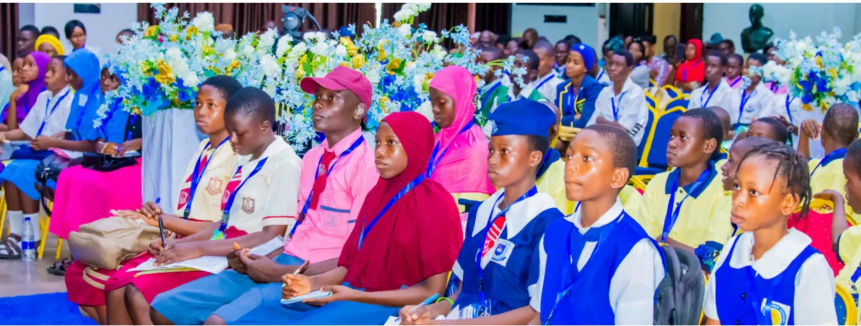 Young people and other guests seated in the forum audience.