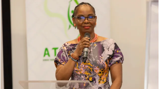 A speaker holding a microphone at a UIRF event.