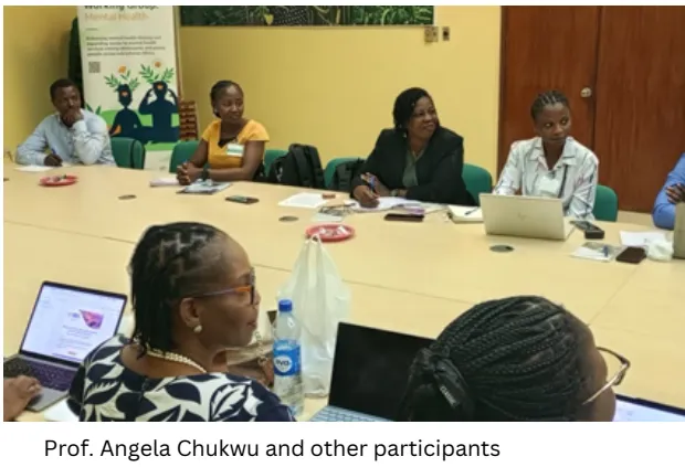 Workshop participants seated around a conference table with laptops and papers.